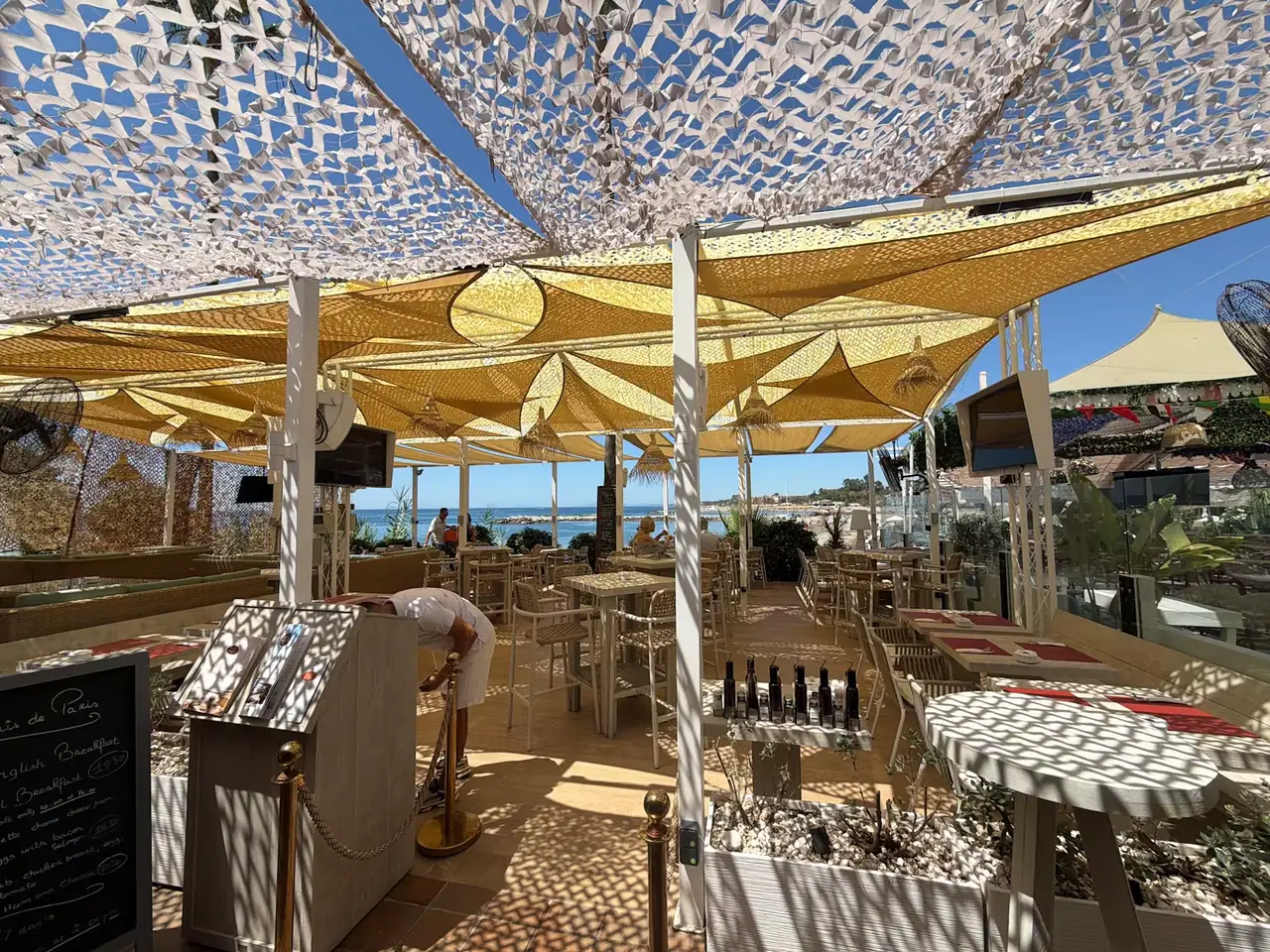 The terrace bar and dining area under the sails on a bright day